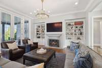 Custom built-in bookcases in the living area add detail around the custom mantle and fireplace.