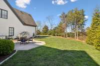 The flat lot backs up to private property, and the backyard is fenced entirely.