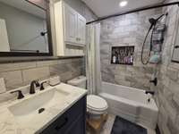 Fully Re-built Bath with New Tile Flooring and Fixtures.