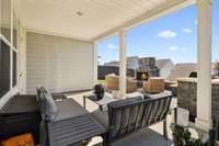 Covered porch with custom hard-scaped patio and fireplace