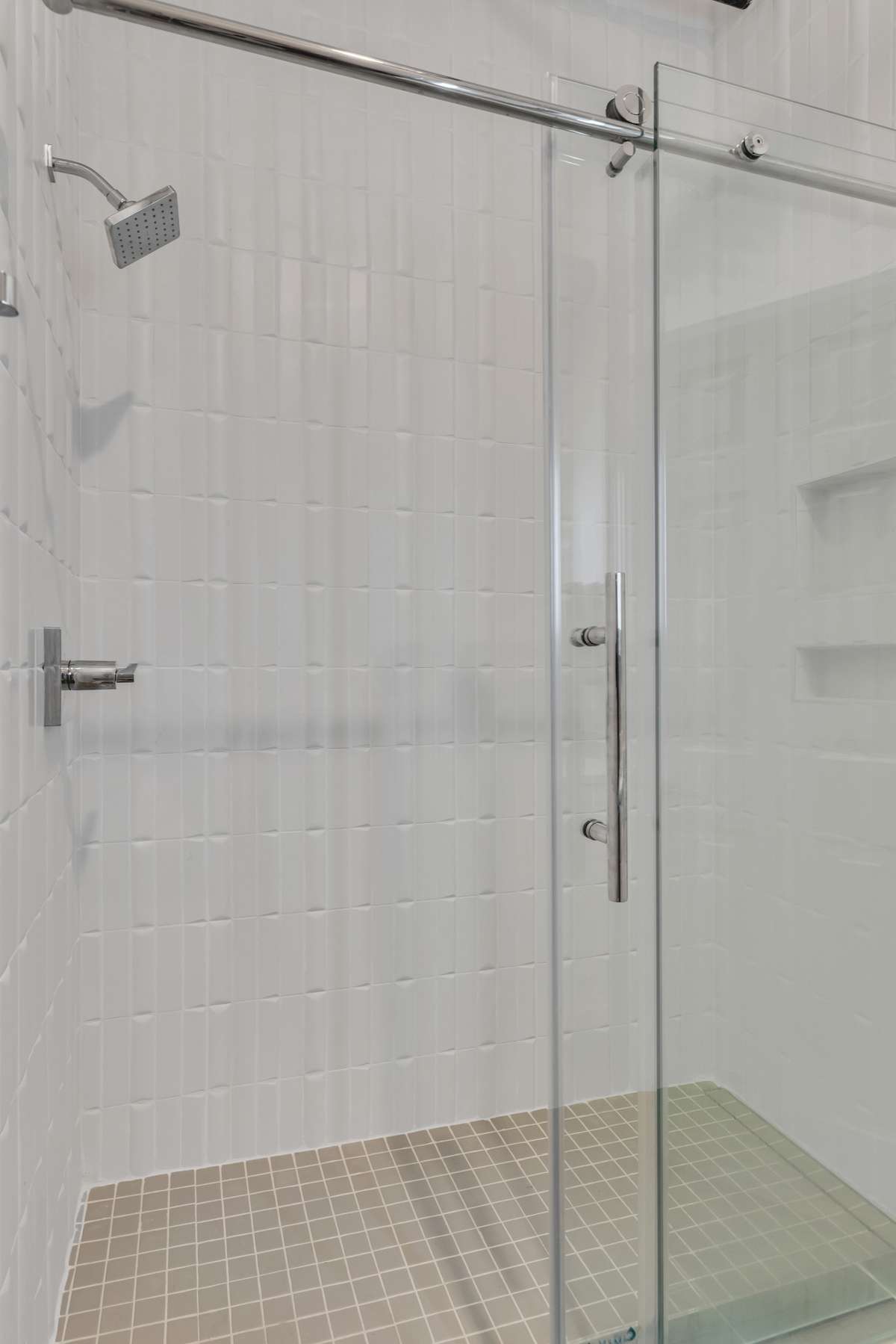 Guest Bathroom features Chic Tiled Shower with Transparent Glass Doors...