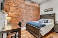 Guest Bedroom  Featuring exposed brick, custom closet system and SKYLIGHT!!