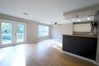Living room opens up to dining room and kitchen.  Doors lead to deck area