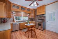 Large kitchen with room for island with seating. Features custom cabinetry, 40" glass top stove and French door refrigerator.
