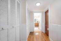 Hall storage galore leading to hall bath