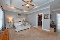 Closet has pocket door and plenty of designer shelving