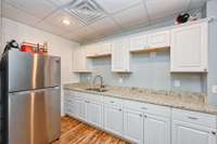 Plenty of kitchen cabinets, sink and refrigerator