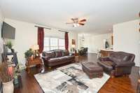 Straight ahead is a spacious den with loads of natural light and open to kitchen