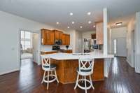 Kitchen opens to den.....and bonus room and door to basement just around the corner