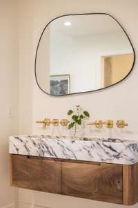 Striking Calcutta Viola marble sink, imported from Turkey, adds a dramatic and elegant focal point to the space.