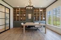 Private office featuring custom built-ins and an abundance of natural light, perfect for remote work, study, or creative space.