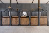 Each stall has a dedicated Dutch door to give the horses enrichment through fresh air, natural light, and a direct view of their surroundings—promoting both comfort and connection to the outdoors.
