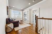 Upstair sitting area w/ built-in entertainment center.