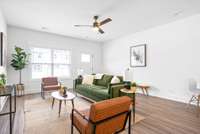 Open concept main level, large living room with ceiling fan and LVT flooring.