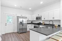 Big spacious kitchen, lots of custom craftsman cabinets with shaker style doors and soft close drawers, stainless steel appliances and granite counters.