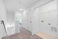 Laundry room and linen closet in upstairs hallway