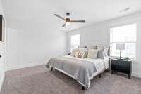 Primary suite upstairs features ceiling fan, full bathroom and walk-in closet