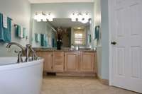 Primary Bathroom with granite countertop and double sinks