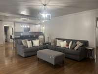 Family Room has hardwood flooring and sliding glass doors that open onto the back deck