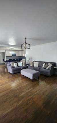 Family Room has hardwood flooring and sliding glass doors that open onto the back deck