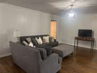 Family Room has hardwood flooring and sliding glass doors that open onto the back deck