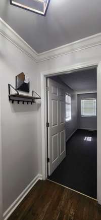 Hall to the Primary Suite, Utility Room, Garage and Kitchen