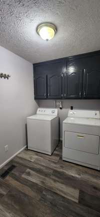 Utility Room with Cabinet Storage is right off the Primary Suite and near the Garage and kitchen