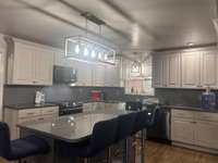 Kitchen with New Cabinets & Apron Sink with soft close drawers, corner turn-around and a Huge Island for seating and extra storage