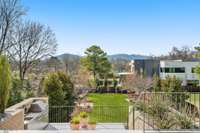 Custom landscaping by Gardens of Babylon frames the panoramic views of Radnor Lake's rolling hills.