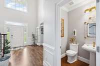 An elegant and updated half bath just off of the foyer.