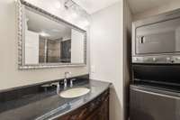 A beautiful vanity. The stackable washer/dryer remain.
