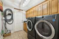 Measures 7'5 x 9'2". Great storage in these cabinets and a sink too which is convenient for gardening. This door leads out to the front yard.