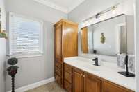 The other side of the Jack-n-Jill bathroom features a large counter and lots of storage.
