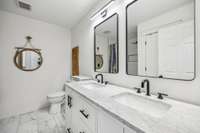 Renovated Guest Bathroom with Dual Vanity, Tile Flooring & Tile Shower/Tub Combo with Glass Door