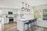 Renovated Kitchen with Quartz Countertops, Tile Backsplash, White Cabinetry, Farmhouse Sink, Gas Range & SS Appliances