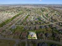 Aerial view with the property clearly outlined, showing its generous lot size and prime location within a beautifully planned community. Great visibility of the surrounding homes, green space, and nearby amenities.