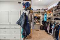 The spacious primary closet offers custom built-ins, ample shelving, and dedicated storage solutions to keep everything organized and easily accessible.