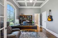 Detailed millwork, a coffered ceiling, and large window make this office both refined and functional. With its own 3/4 bath and closet, it easily doubles as a guest suite.