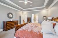 The primary suite offers direct access to a spacious ensuite bath and large walk-in closet. Elegant trim and soft lighting complete the calming atmosphere of this retreat.
