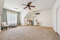Spacious upstairs bonus room or bedroom with its own private half bath. Features a large window for great natural light, built-in vanity, and independent climate control for comfort year-round.