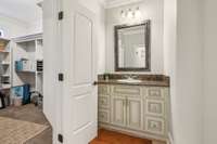 This Jack and Jill bathroom features separate vanities for privacy and convenience. Elegant cabinetry and granite counters add a polished look, while each bedroom enjoys direct access for a seamless and functional layout.