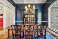 A built-in niche with lighting provides the perfect display space for a hutch or buffet, adding function and style to this elegant dining room.