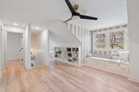 2nd-floor landing area with beautiful hardwoods, two walk-in closets for storage, custom built-ins, two custom beds, and a second laundry room.