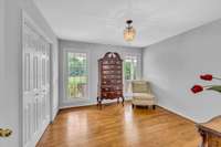 This bedroom is located on the main floor.  More hardwoods, fresh paint, new lighting and it overlooks the long front porch.  The walls are empty so moving in and adding your own decor will be a piece of cake.