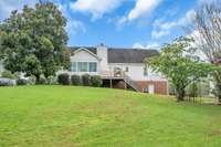Back view of the house from the pool area.  There is a gentle slope.