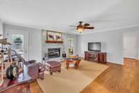 The living room has a whitewashed brick fireplace with gas logs, fresh paint, hardwood floors and a door leading to the back deck.  Not much furniture in the room now, but you can easily have a sectional if you wanted.