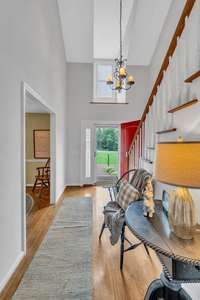 This view of the entrance foyer is from the living room looking back at the front door. Lots of natural light from the overhead dormer.