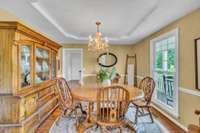Separate dining area with trey ceiling & hardwood floors is currently the most formal room n the home but could easily be converted to a home office, library or more. The wall color is very warm & inviting.
