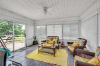 The sunroom has 3 sided windows/door, ceiling fan, tile flooring and overlooks the backyard and pool area.  The sliding door leads to the deck.