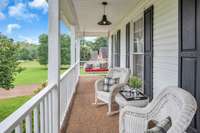 This end of the porch offers some wicker furniture and a swing (both convey) to take a breather and enjoy a lazy Saturday afternoon.